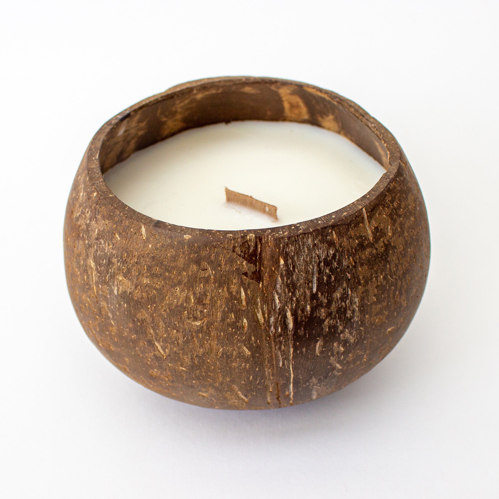 Hand-poured toasted coconut soy wax candle in a natural coconut shell
